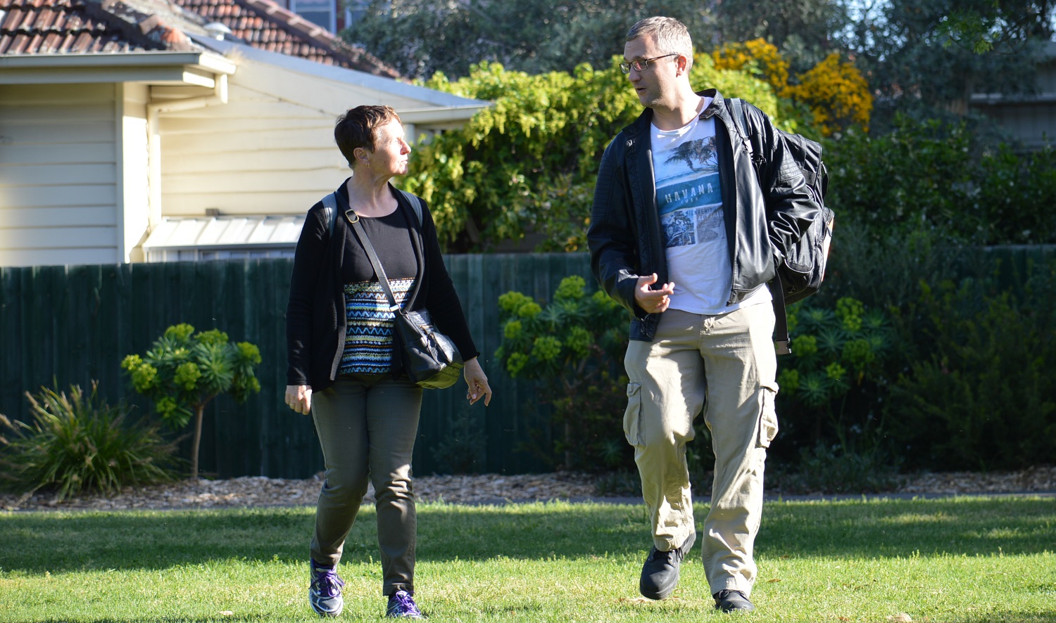 Two people walking together in a park - for 10 tips story. Walk with a friend. October 2017 photo shoot.